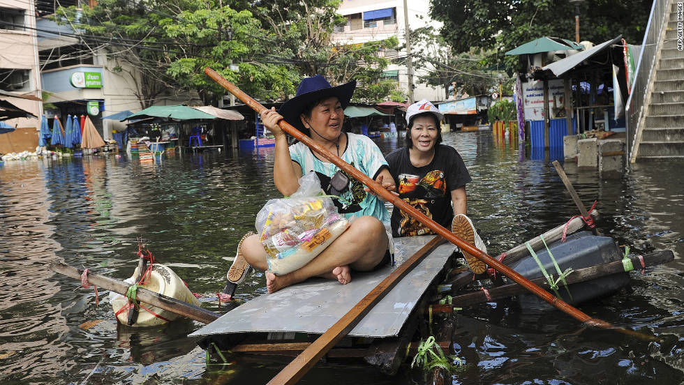 Bangkok residents paddle a makeshift boat through floodwaters on Sunday, October 30. Thai officials warned residents in the capital to be vigilant and expect disruptions with electricity and tap water as Thailand battles its worst flooding in decades.