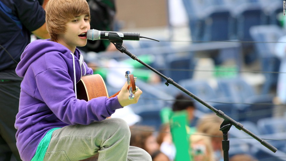 The Stratford, Ontario, native first attracted attention on YouTube before the rest of the world noticed him. Here Bieber, in his signature purple hoodie, entertains crowds at Arthur Ashe Kids' Day, a U.S. Open event, in New York in August 2009.