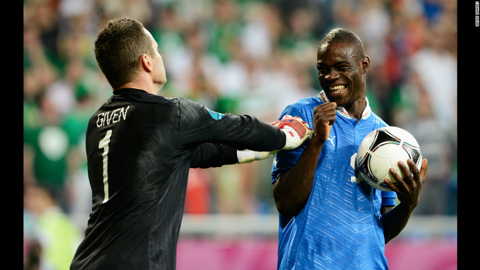 Italy's Mario Balotelli smiles at Ireland's Shay Given.