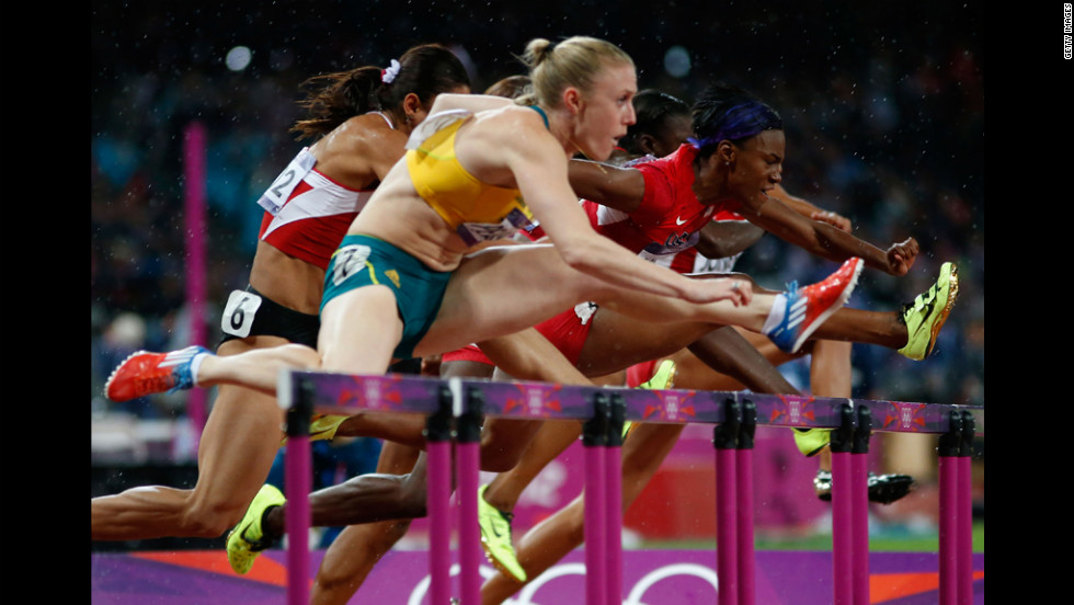 Sally Pearson of Australia leads Nevin Yanit of Turkey and Kellie Wells of the United States during the women's 100-meter hurdles final.