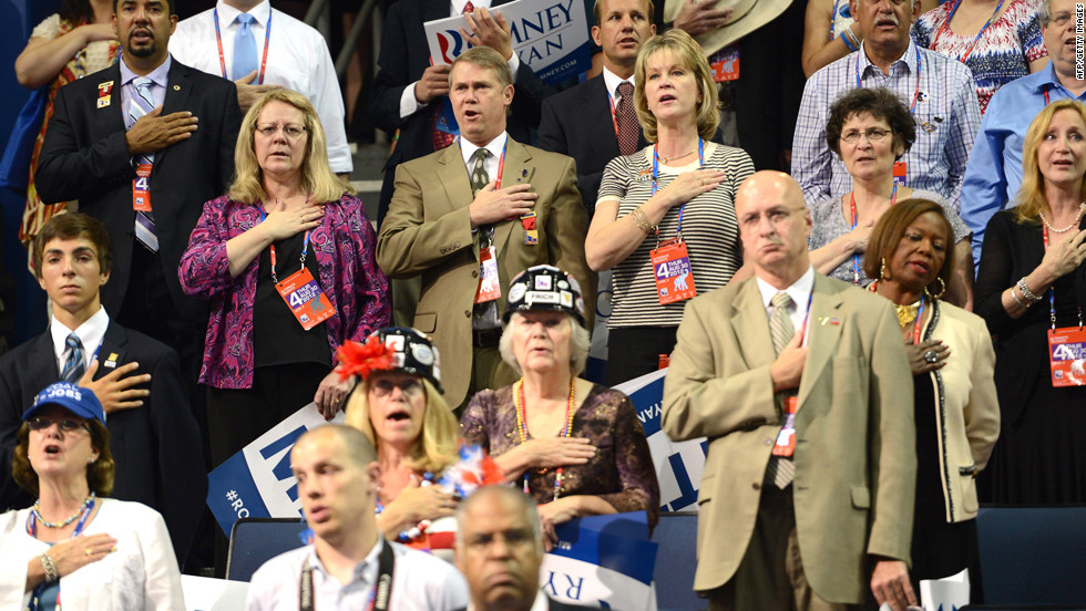 Delegates listen to the national anthem at the Tampa Bay Times Forum.