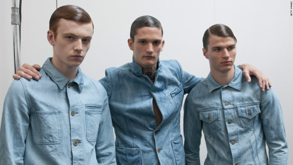 Three male models looking sleek backstage at the Duckie Brown Spring 2013 fashion show.