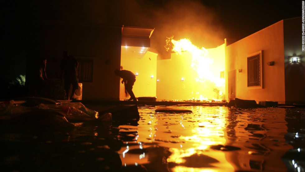 People duck flames outside a building on September 11.