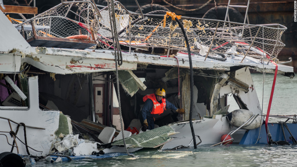 A fireman inspects the back end of the badly damaged Lamma IV passenger boat two days after the collision.