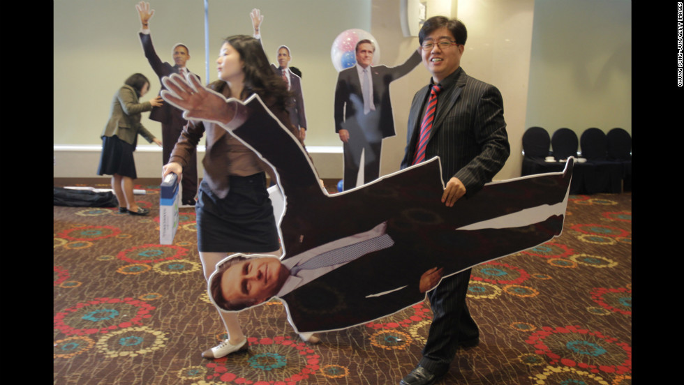 A South Korean man carries a cutout picture of Republican presidential candidate Mitt Romney after an election screening Wednesday in Seoul.