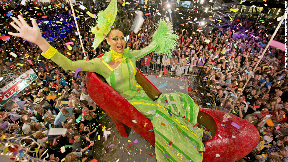 Gary Marion, portraying female impersonator Sushi, hangs in an oversized replica of a women's red high heel over Duval Street in Key West, Florida. The Red Shoe Drop has become a Key West tradition.