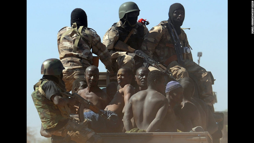 Malian soldiers transport in a pickup truck a dozen suspected Islamist rebels on Friday, February 8, after arresting them north of Gao. A suicide bomber blew himself up on February 8 near a group of Malian soldiers in the northern city, where Islamist rebels driven from the town have resorted to guerilla attacks.