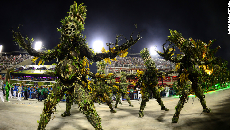 Imperatriz Leopoldinense samba school perform wearing elaborate costumes during Carnival parades at the Sambadrome.