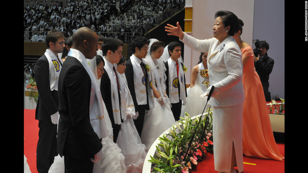 Hak Ja Han Moon, right, the widow of the late Unification Church founder Sun Myung Moon, sprinkles the church's holy water onto newly married couples. This was the first Cosmic Blessing since the death of Sun Myung Moon, who <a href="http://www.cnn.com/2012/09/02/world/asia/south-korea-reverend-moon-dead" target="_blank">passed away in September 2012</a>.