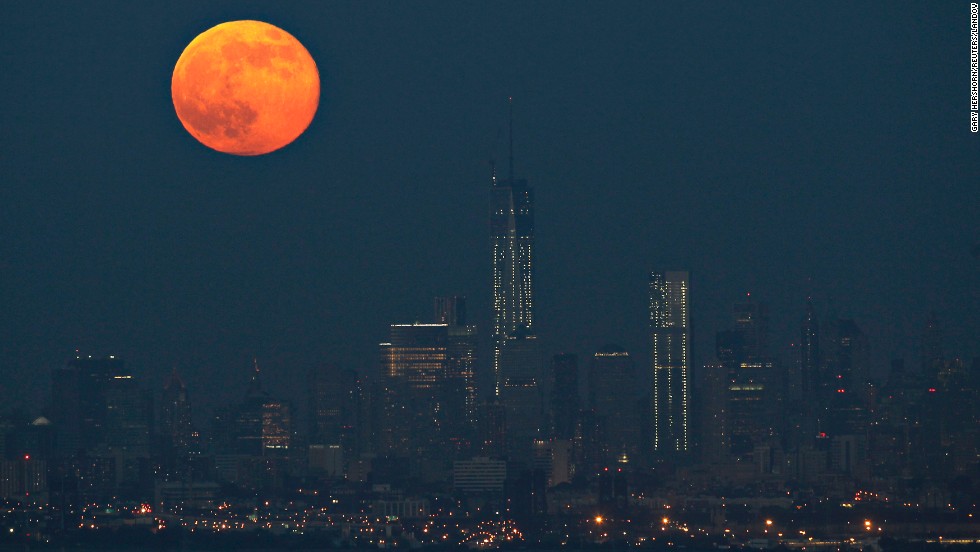 The moon hangs over the Manhattan skyline on June 23.