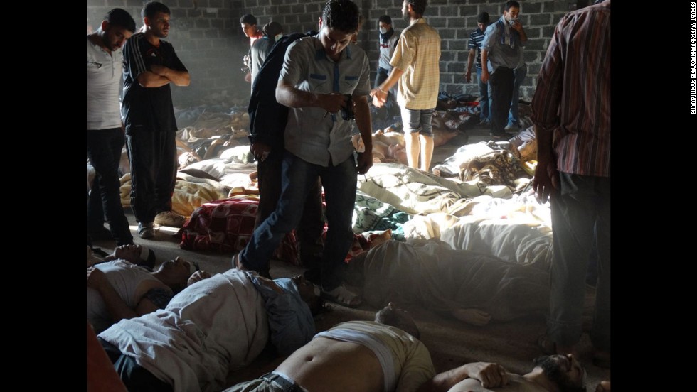 Syrian rebels claim pro-government forces used chemical weapons to kill citizens outside Damascus on Wednesday, August 21. People inspect bodies in this photo released by the Syrian opposition Shaam News Network.