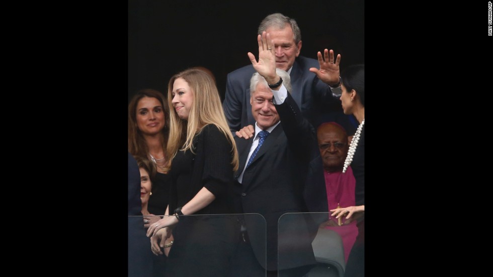 Former Presidents Bill Clinton and George W. Bush wave during the memorial service. Chelsea Clinton is at left.
