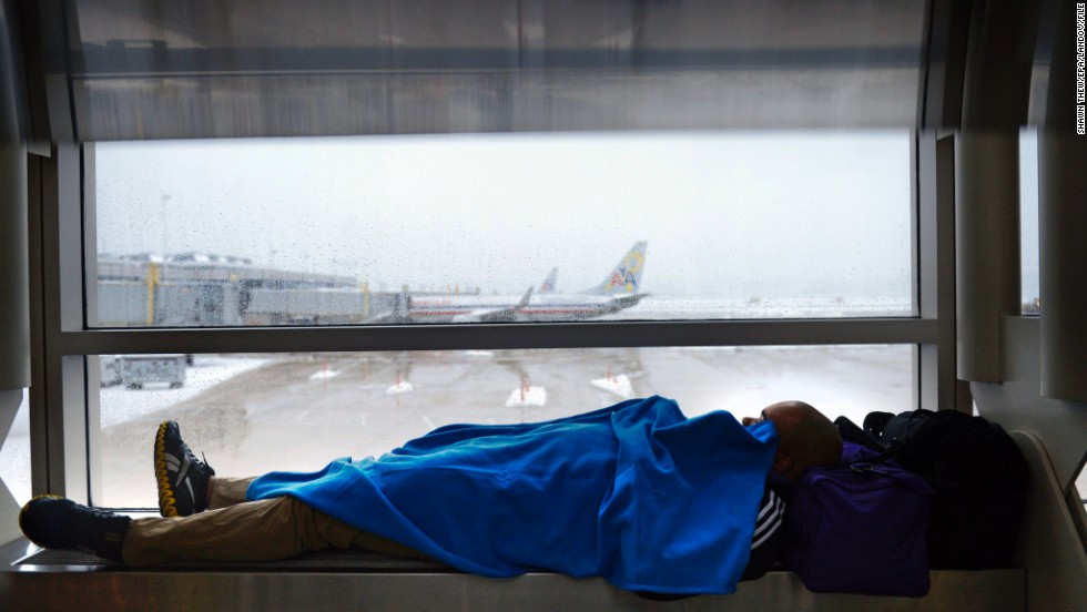 A traveler kills time as work crews continue to clear snow from the runways at Reagan National Airport in Arlington, Virginia, on February 13.