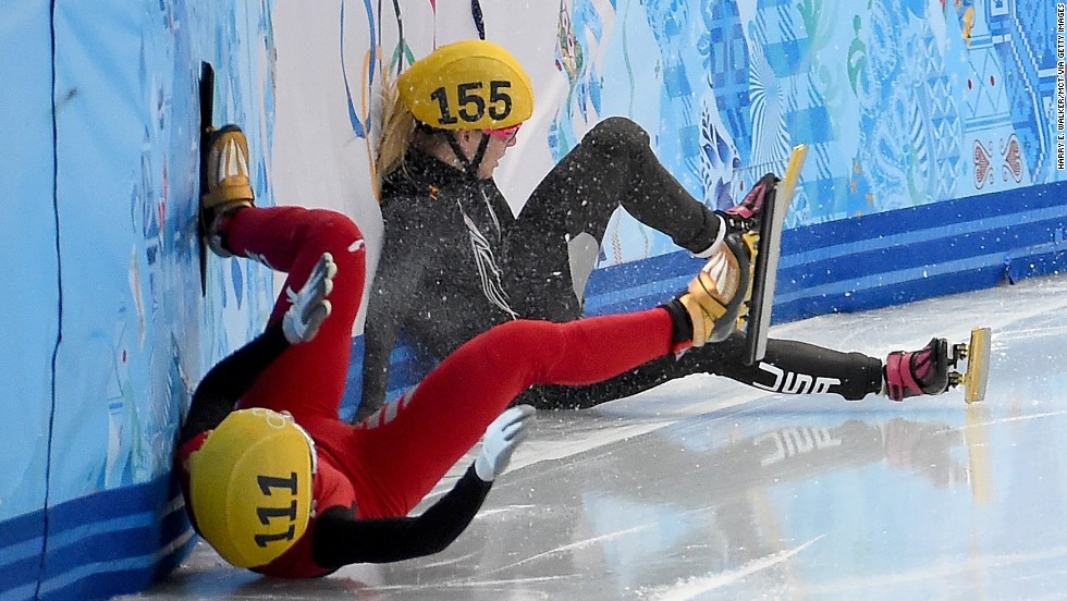 China's Alang Ki, in red, and the USA's Emily Scott crash into the wall after colliding during the finals of the women's 1,500-meter short track speedskating race on February 15.