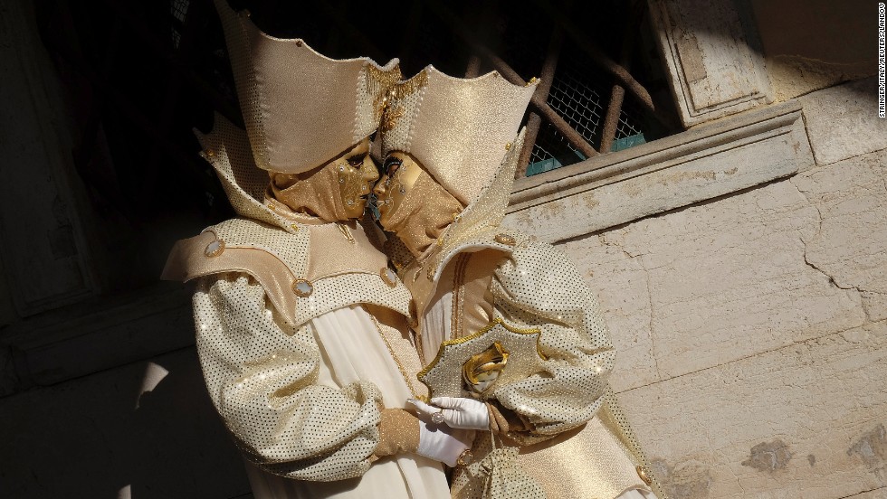 Masked revelers pose during the Venetian Carnival in Venice, Italy, on Sunday, February 23. <a href="http://www.cnn.com/2014/02/18/travel/most-colorful-carnivals/index.html">Colorful carnival celebrations</a> are under way in cities around the world.