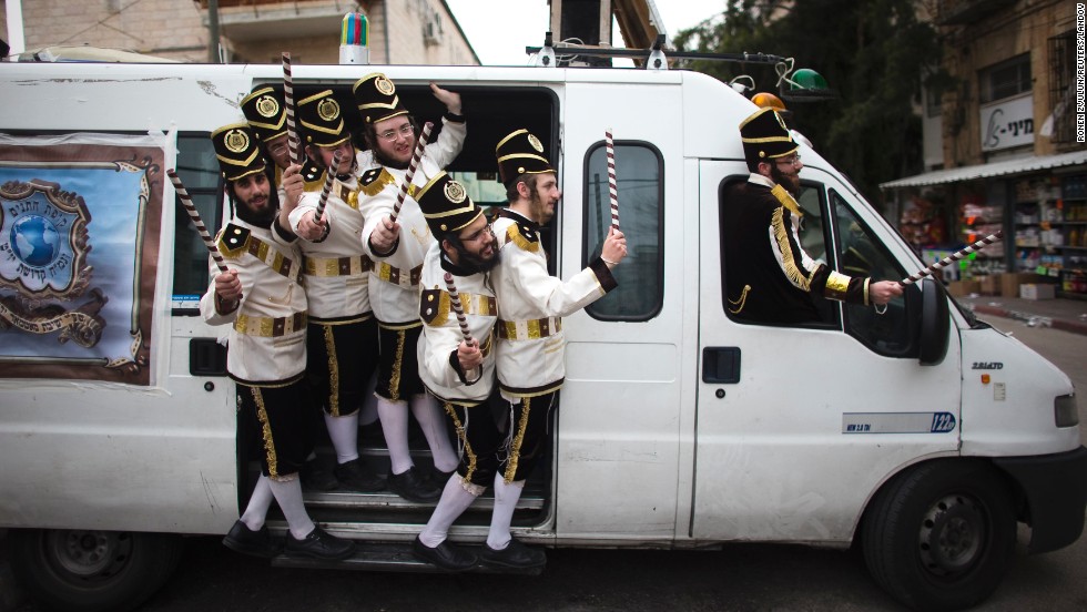 Ultra-Orthodox Jewish men wear costumes as they celebrate the Purim holiday Monday, March 17, in Jerusalem.