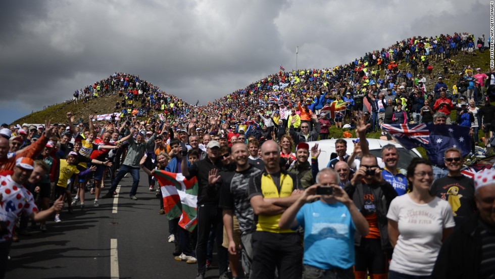 Cycling spectators are seen along a road in England during the first stage of the Tour de France on Saturday, July 5. The legendary road race began in Leeds, England, and will end in Paris on July 27.