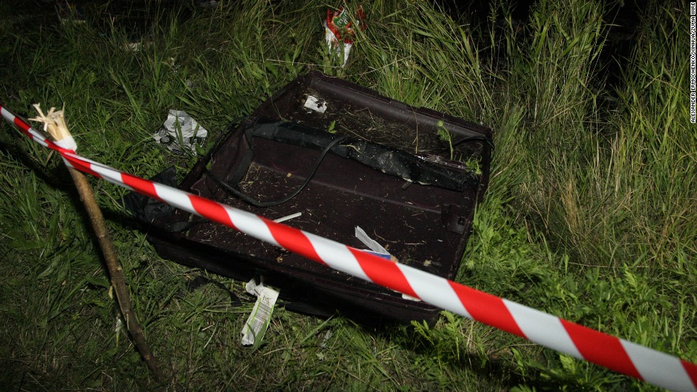An empty suitcase is cordoned off near the plane's impact site on Thursday, July 17.