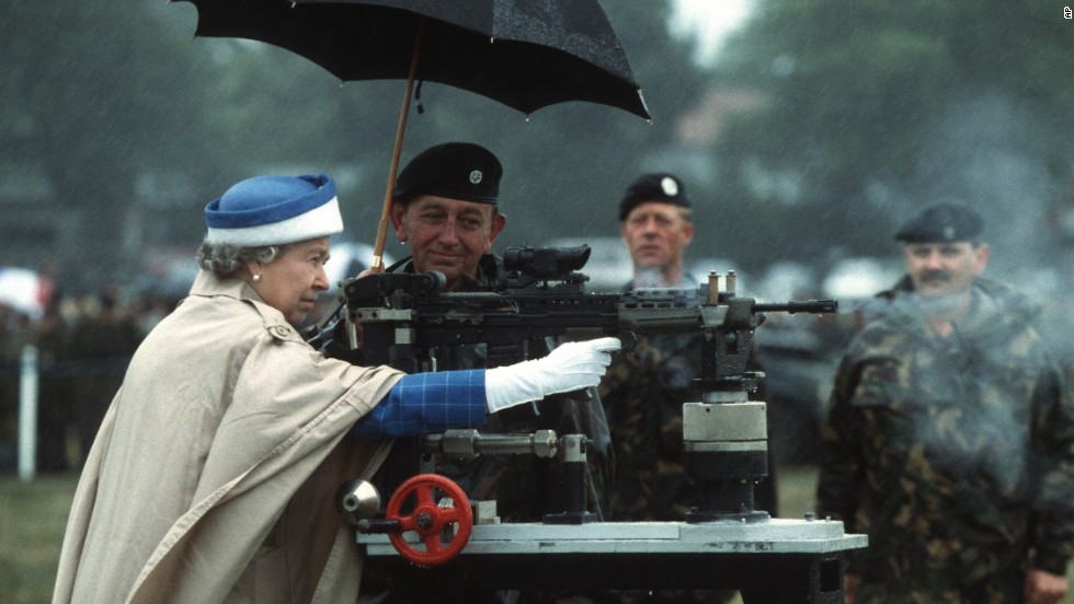 Queen Elizabeth II fires a rifle during a visit to the Army Rifle Association at Bisley, England, in July 1993.