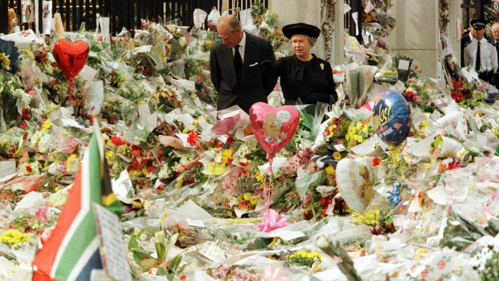 While at Buckingham Palace, Queen Elizabeth II and Prince Philip view the floral tributes to Princess Diana after her tragic death in 1997.