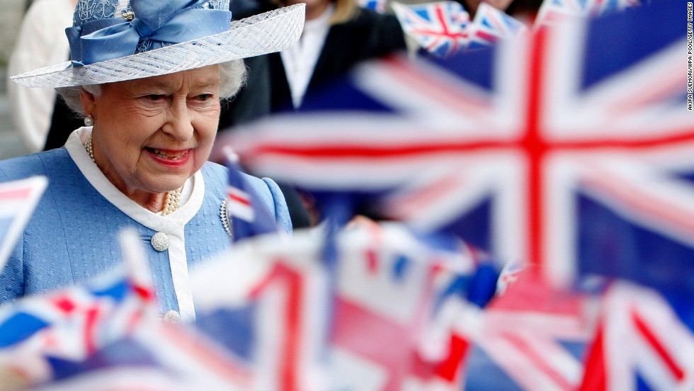 Flags are waved as Queen Elizabeth II leaves St. Paul&#39;s Cathedral following its 300th anniversary service in June 2011.