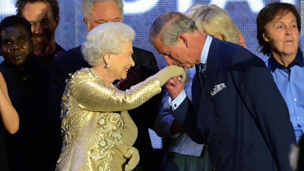 Prince Charles kisses his mother&#39;s hand on stage as singer Paul McCartney, far right, looks on at the Diamond Jubilee concert held June 4, 2012, at Buckingham Palace. The Diamond Jubilee celebrations marked Elizabeth&#39;s 60th anniversary as Queen.