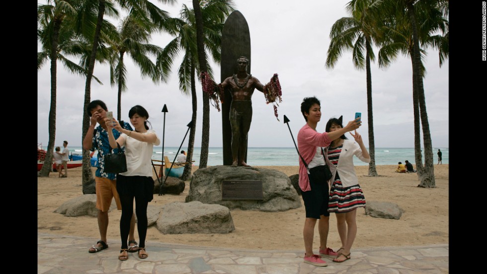 Tourists take selfies in front of the Duke Kahanamoku statue in Honolulu on Friday, August 8. Kahanamoku was an Olympic gold medalist in swimming who is credited with bringing surfing to the outside world. <a href="http://www.cnn.com/2014/08/06/world/gallery/look-at-me-0806/index.html">See 18 selfies from last week</a>