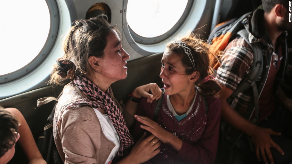 Aziza Hamid, a 15-year-old Iraqi girl, cries for her father while she and some other Yazidi people are flown to safety Monday, August 11, after a <a href="http://www.cnn.com/2014/08/11/world/gallery/kurdistan-rescue-mission-mount-sinjar/index.html">dramatic rescue operation</a> at Iraq's Mount Sinjar. A CNN crew <a href="http://www.cnn.com/2014/08/11/world/meast/iraq-rescue-mission/index.html">was on the flight,</a> which took diapers, milk, water and food to the site where as many as 70,000 people remain trapped by the militant group ISIS. But only a few of them were able to fly back on the helicopter with the Iraqi Air Force and Kurdish Peshmerga fighters.