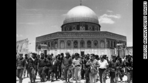 In June 1967, Israeli statesman David Ben-Gurion and Yitzhak Rabin lead a group of soldiers past the Dome of the Rock on the Temple Mount, on a victory tour following the Six Day War.
