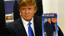 Trump poses with the new Donald Trump 12-inch talking doll on September 29, 2004, at the Toys 'R' Us store in New York City.