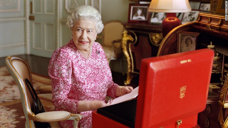 The Queen sits at a desk in Buckingham Palace in July 2015.