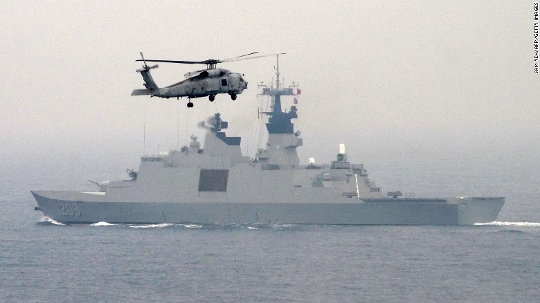 A US-made S-70C helicopter files over a French-made Lafayette frigate during a drill at sea near the naval port in Kaohsiung in southern Taiwan on January 27, 2016. The Taiwanese military launched a series of mini military drills the last two days to display their determination to defend itself against China amid concerns if tensions would be stoked across the Taiwan Strait following the island&#39;s recent presidential vote.