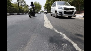 A road in New Delhi melts as the temperature reaches 43 degrees Celsius (109 degrees Fahrenheit) on Thursday, May 19. Much of India is reeling from a heat wave and severe drought conditions that have decimated crops, killed livestock and left at least 330 million people without enough water for their daily needs. 