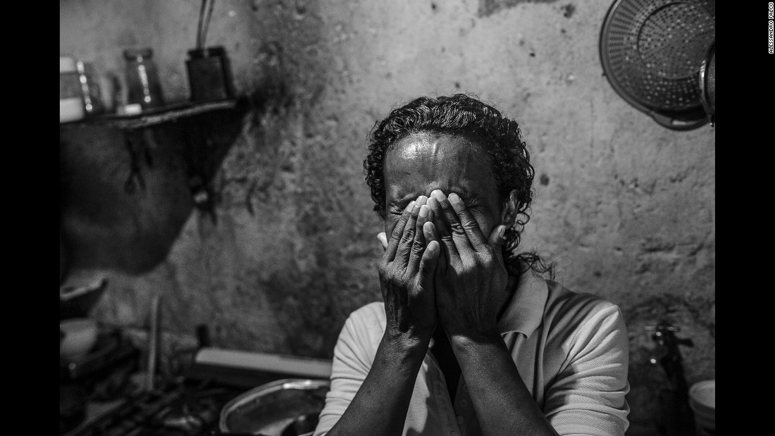 Paula, 48, bursts into tears as she recalls how life in Venezuela has changed in a few years. She is cooking chicken feet for lunch -- a meal she said she used to give to her dog.