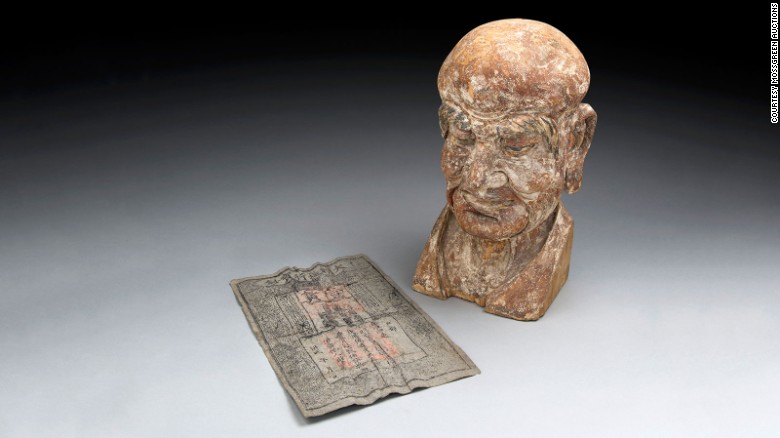 Specialists at Mossgreen auctions in Australia discovered this Ming dynasty banknote hidden inside the head of this 14th century Buddhist carving. The wooden sculpture represents the head of a Luohan -- an enlightened person who has reached Nirvana in Buddhist culture. 