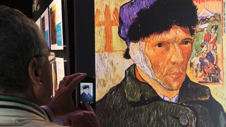 A visitor snaps a picture of &quot;Self-Portrait with Bandaged Ear,&quot; by Dutch artist Vincent Van Gogh.