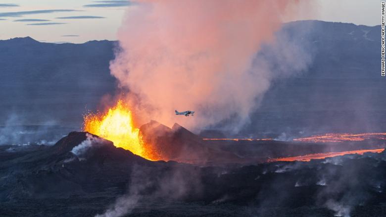 An aerial picture taken on September 14, 2014 shows a plane flying over the Bardarbunga volcano spewing lava and smoke in southeast Iceland. 