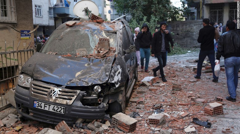 People walk through the debris from an explosion in the Turkish city of Diyarbakir on November 4.