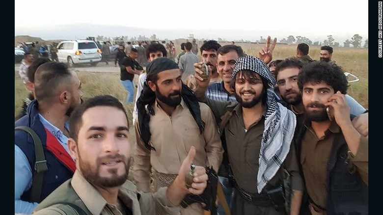 Ako Abdulrahman, center, rescued dozens of people by driving them to safety in his bulletproof BMW. 