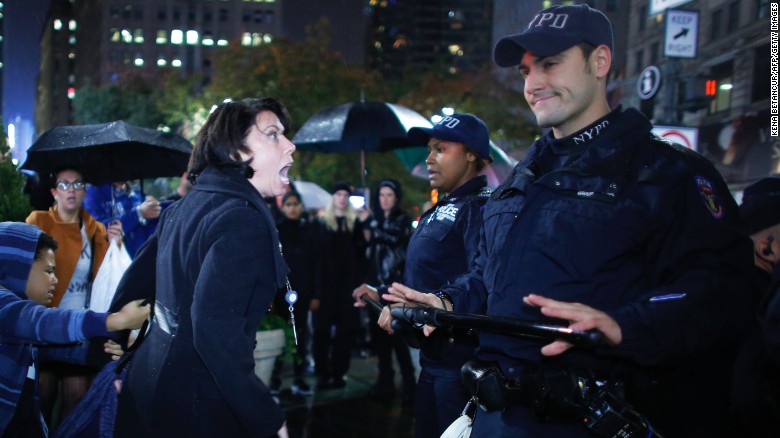 A woman argues with New York City police officers during a protest against President-elect Donald Trump.