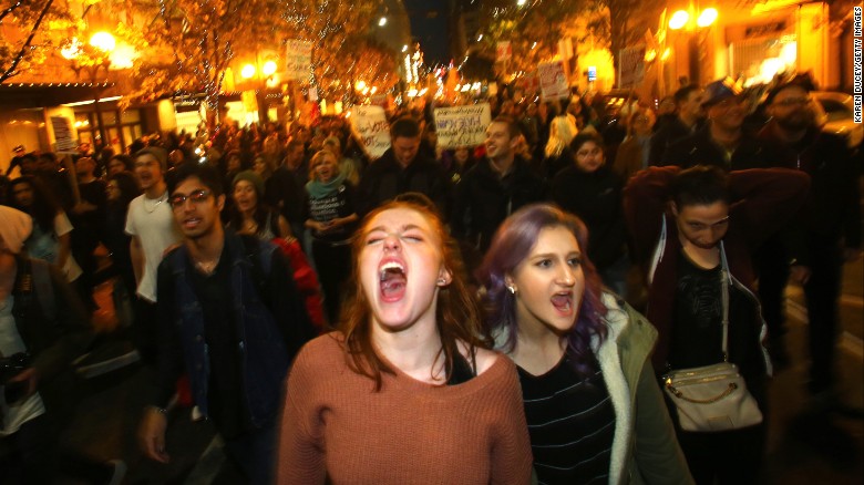 Sasha Savenko, left and Sydney Kane join thousands of protesters in Seattle.