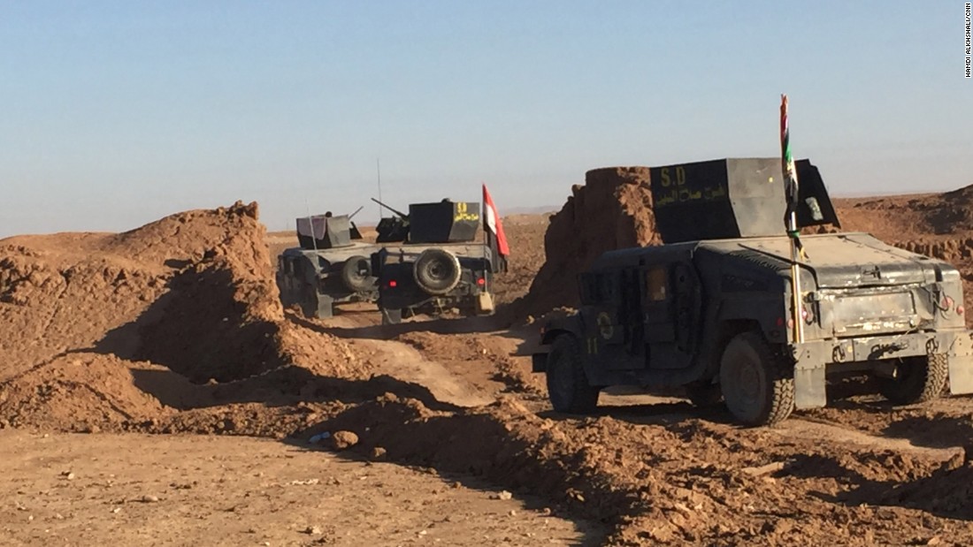 Armored Humvees from Salahuddin regiment cross the defensive berm heading towards eastern Mosul.