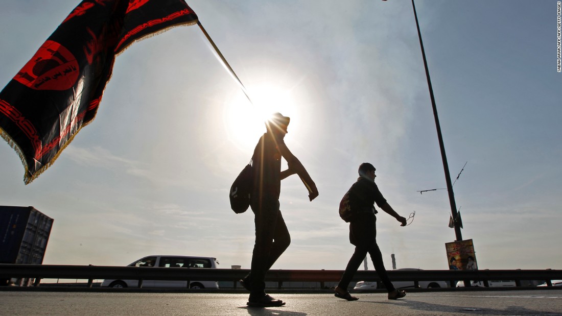 Shiite Muslim pilgrims walk on a road on the southern outskirts of Baghdad towards the holy city of Karbala ahead of the Arbaeen religious festival.