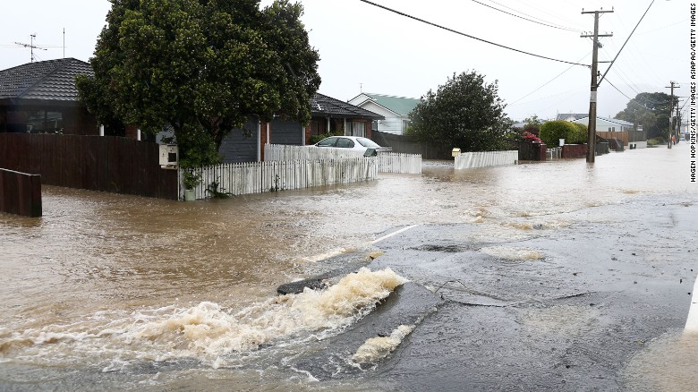 Flood water flows through cracks in the road surface on Udy Street after severe weather, November 15, 2016 in Wellington.