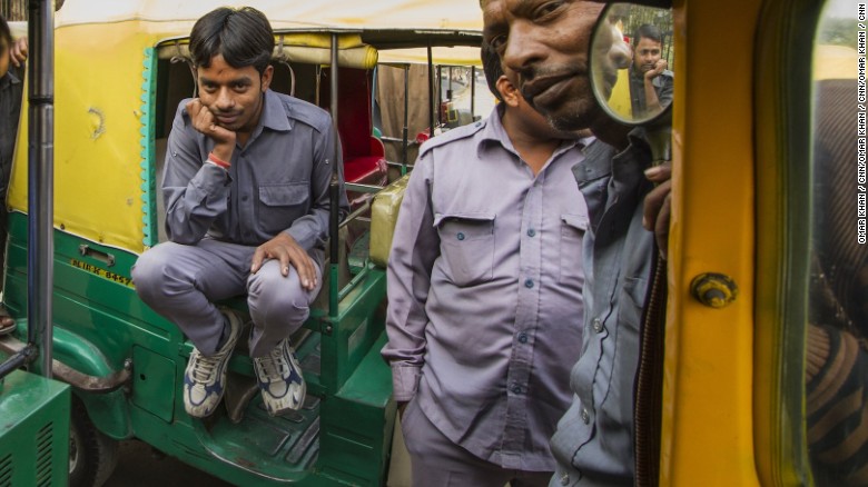 Sarvesh on his auto rickshaw with other drivers. 