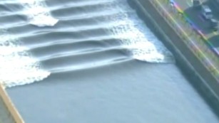 A &quot;tidal bore&quot; forced by Monday&#39;s  tsunami in eastern Japan moves through a canal. 