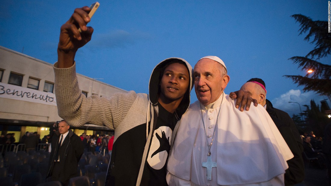 Pope Francis poses for a selfie during his visit to a refugee center in Rome on Thursday, March 24.