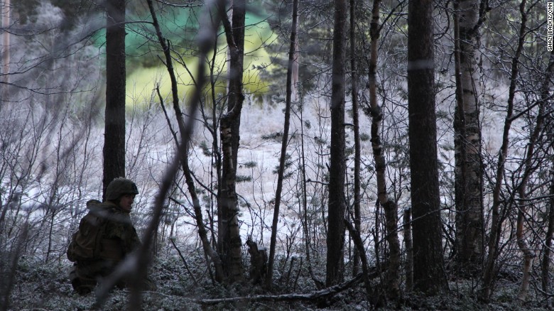 Yellow and green smoke floats through the Norwegian forest during the war games.