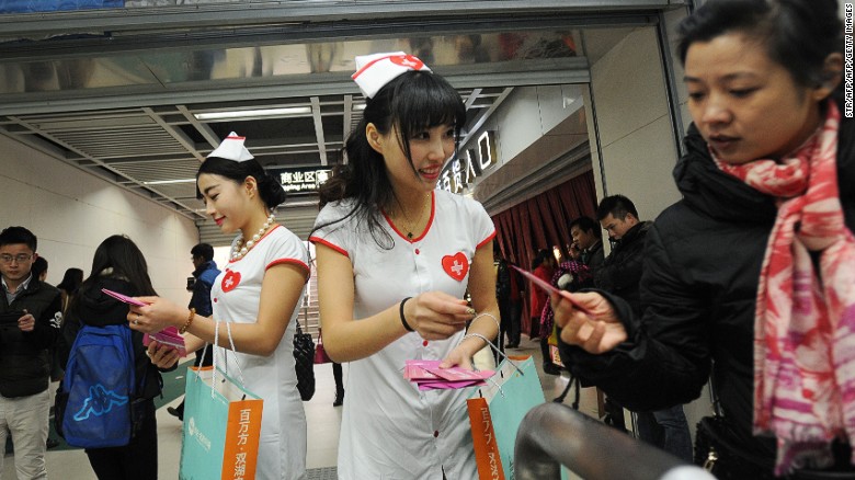 Volunteers hand out condoms in a subway station in Wuhan on World AIDS Day.