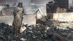 A statue of Jesus was the only thing left standing after the wildfires swept through this house in Sevier County, Tennessee.